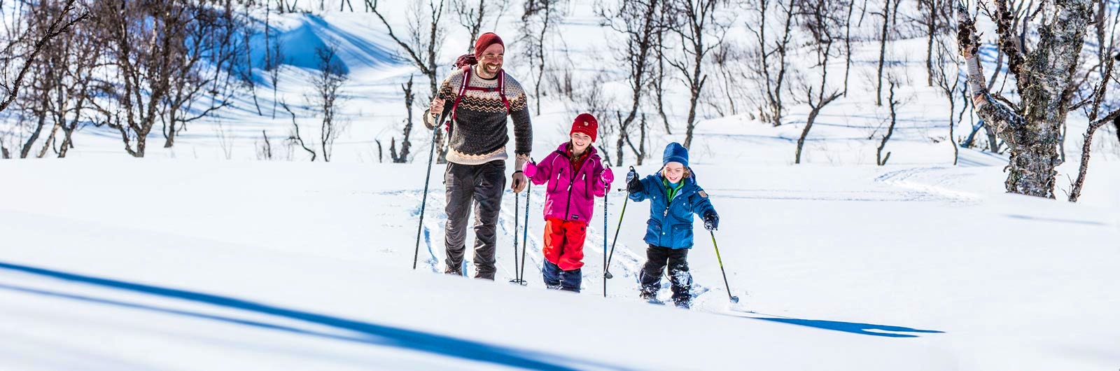 Family of three skiing