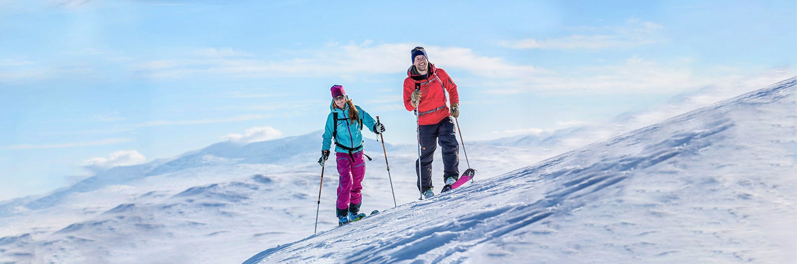 Couple summit skiing