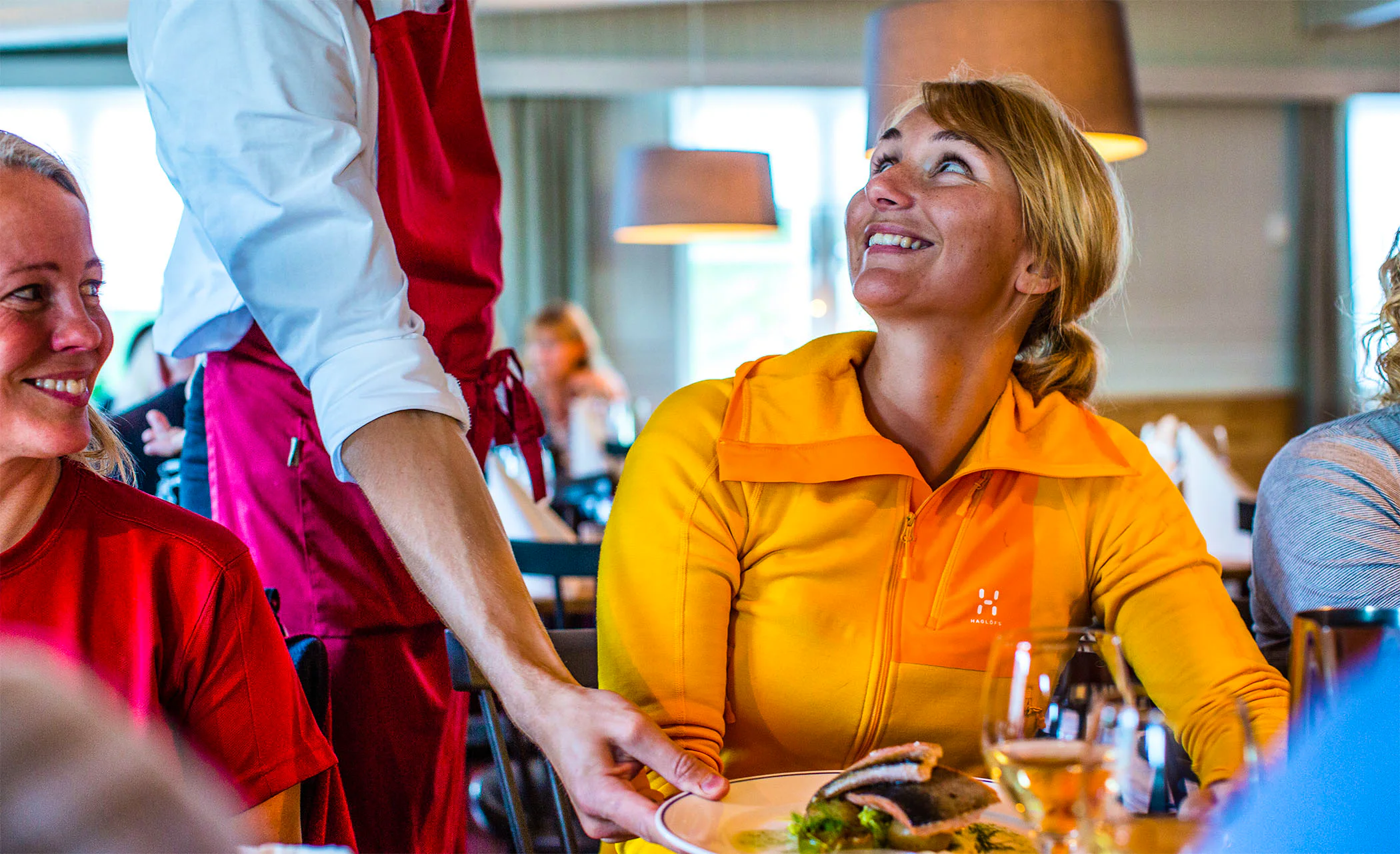A woman getting dinner served at STF Kebnekaise Restaurant.