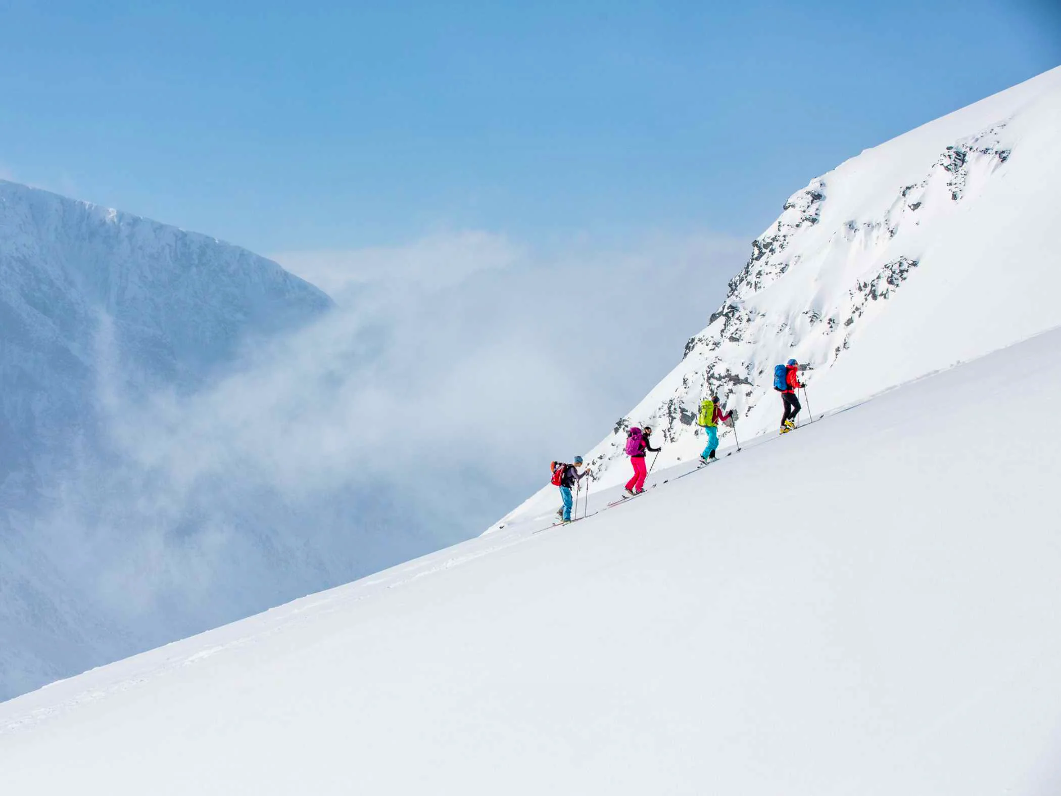 Ski tourers ascending a snow-covered slope in the Kebnekaise mountains, Swedish Lapland.