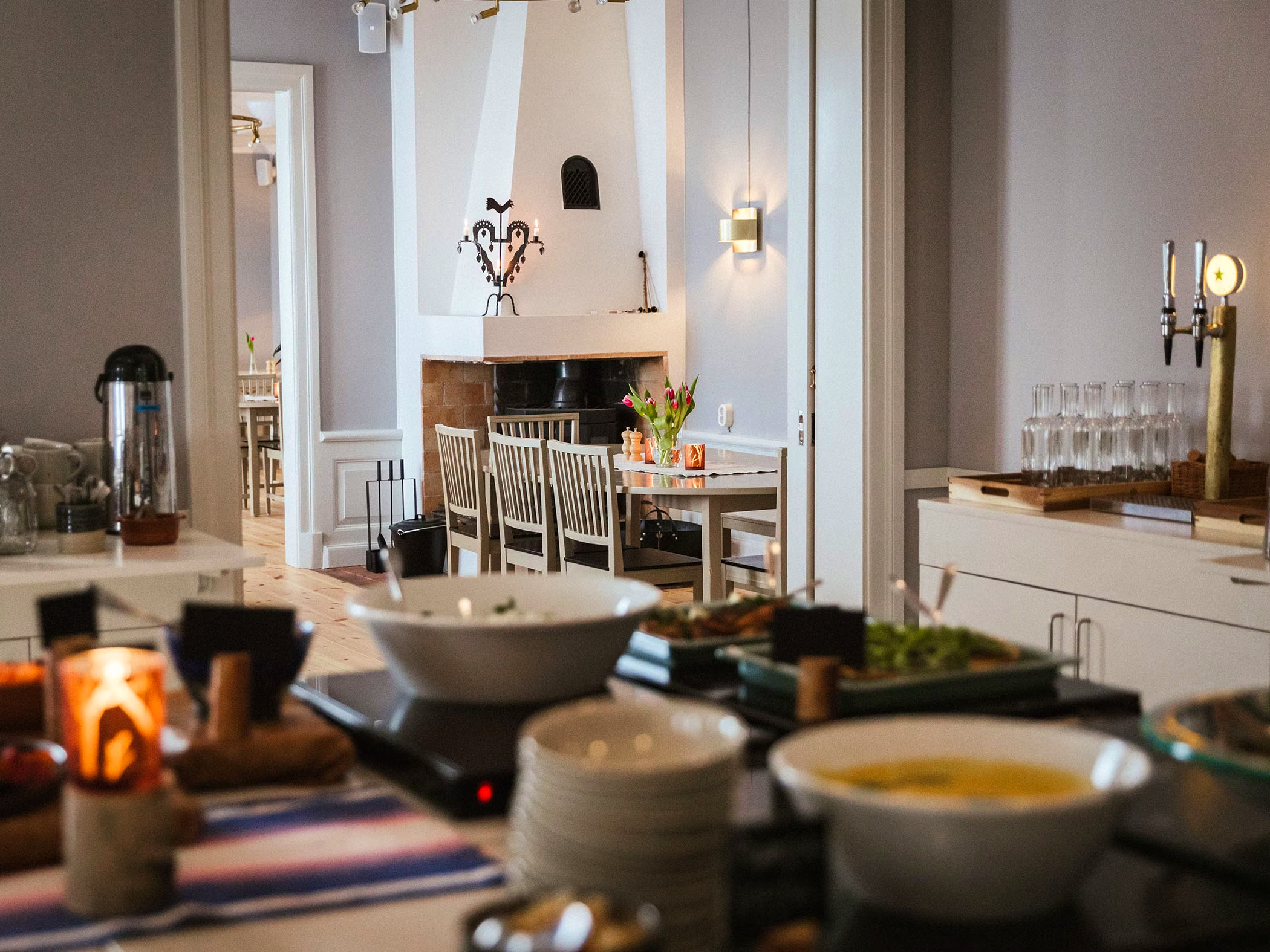 A served buffet in a room with a fire place.