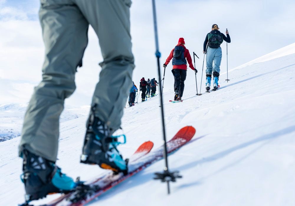 A group of people walking on skis up on a mountain.