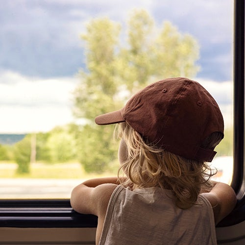 Child looking out of a train window.