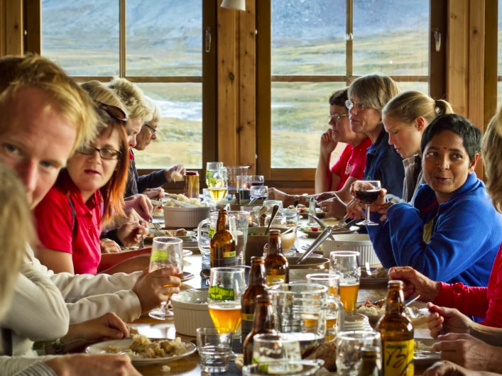 A group of people sitting around a table eating food.