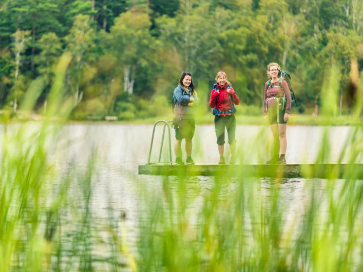 Three people standing on a jetty on Signature trail Göteborg.