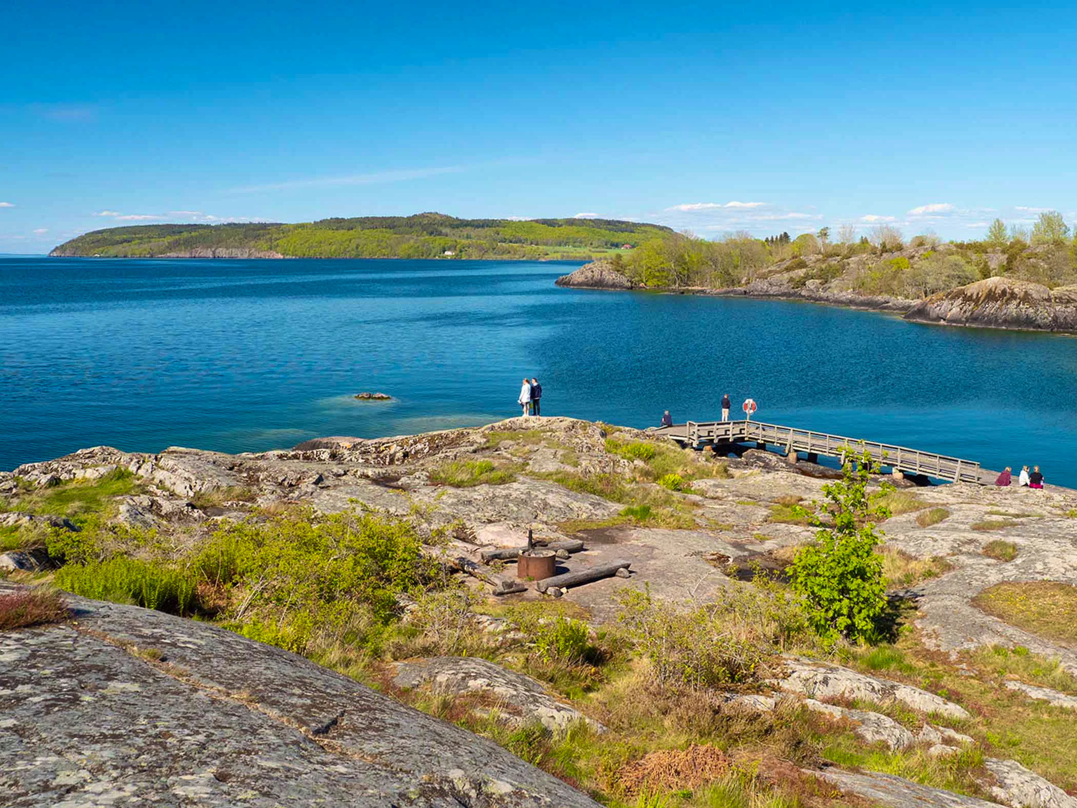 Two people standing by the water along Signature trail Omberg.
