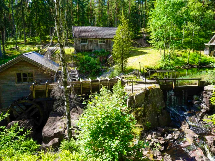 Old houses by a river at Tolltorps industrimuseum.