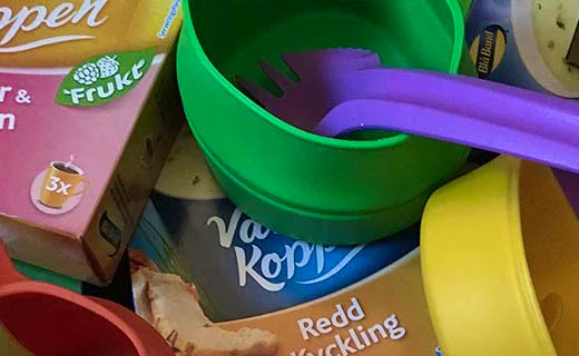 Packaged food and camping utensils for outdoor meal preparation.