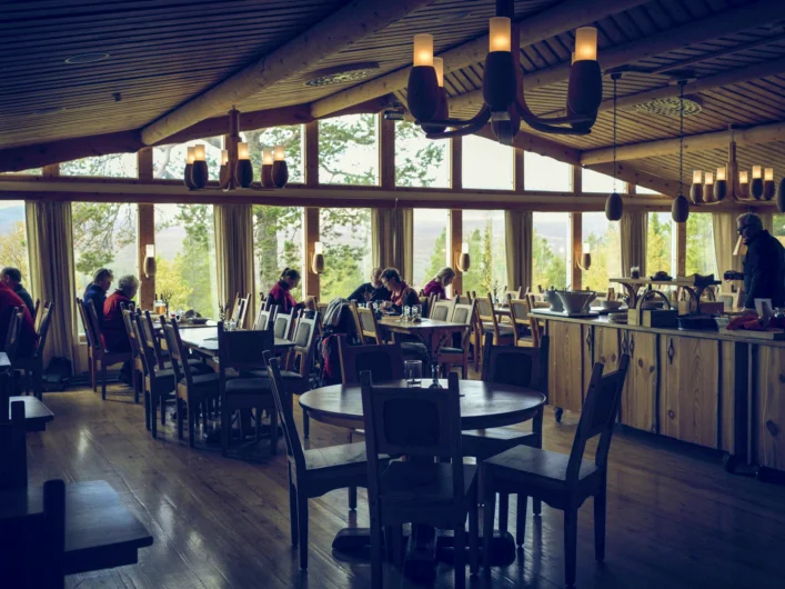 A restaurant with a lot of tables and chairs.