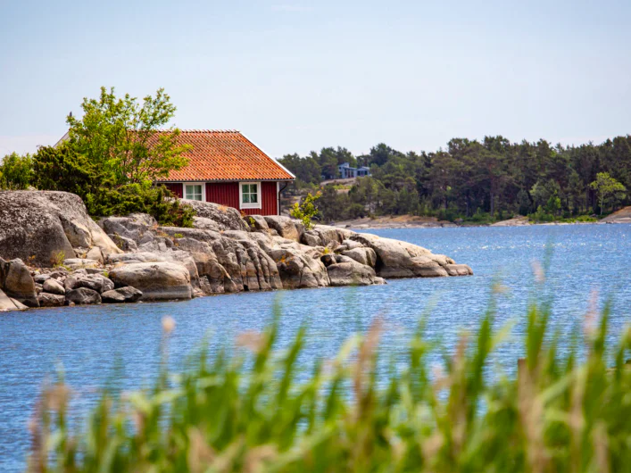Small red cabin on a rocky islet in the Stockholm archipelago.